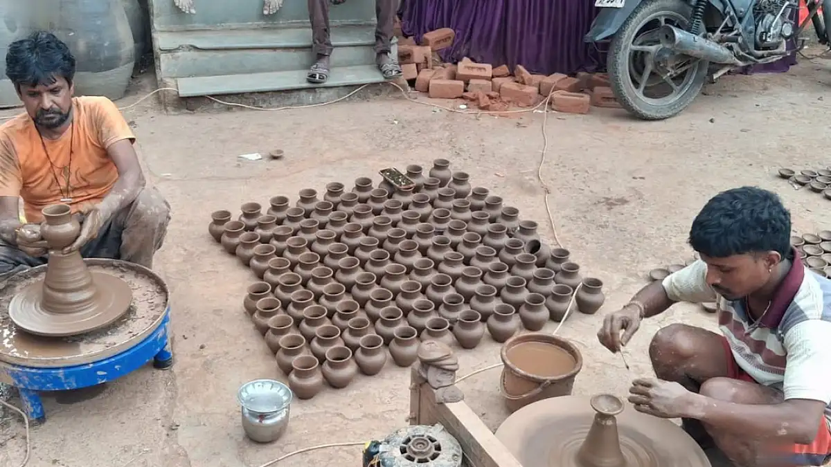 Craftsmen making clay lamps in a workshop