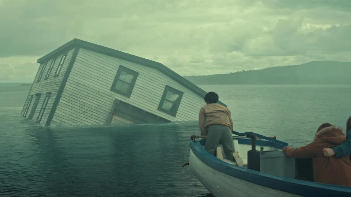A person in a boat on a rugged coastline