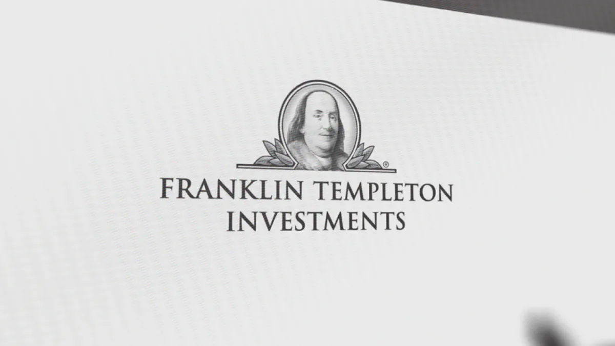 A person looking at a stock market screen