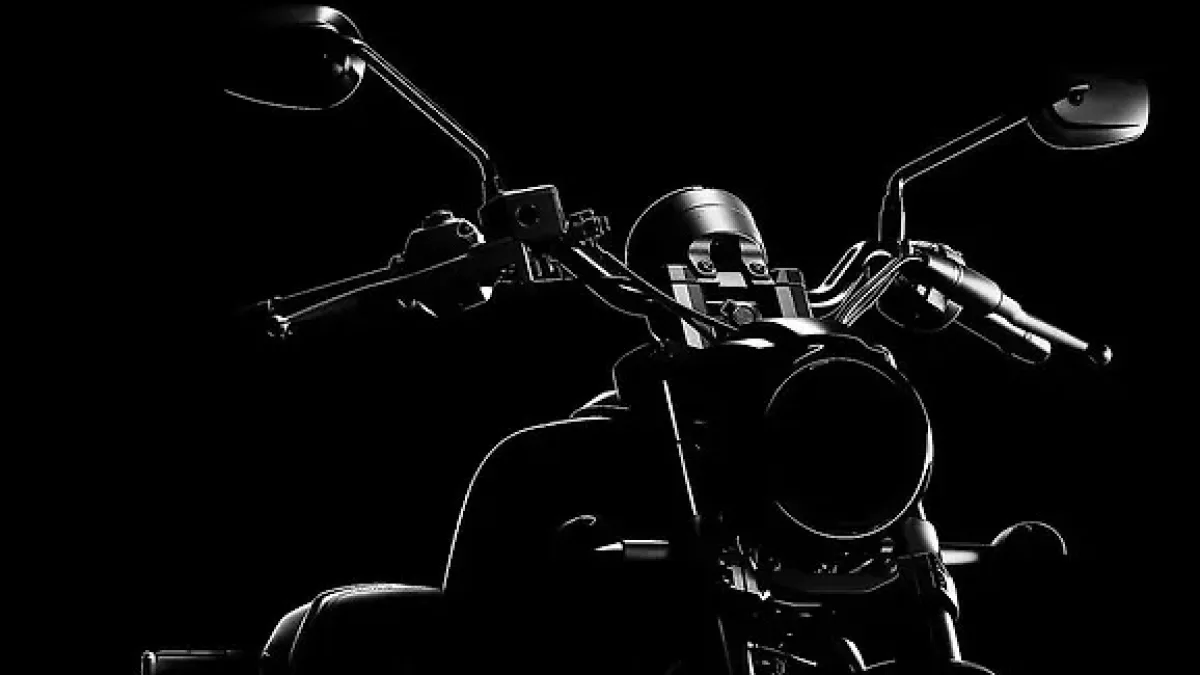 A cruiser motorcycle with a round headlamp and swept-back handlebar