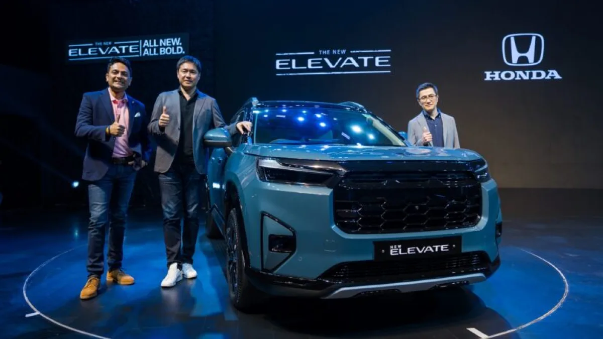 SUV on a road with a cityscape in the background