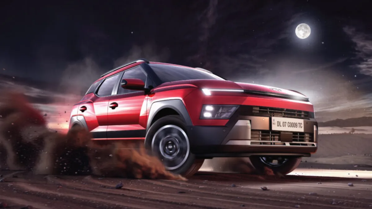 SUV on a road with a cityscape in the background