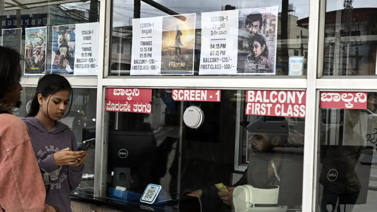 A crowded movie theatre with people watching a film