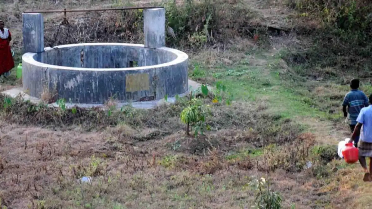 People collecting water from a well