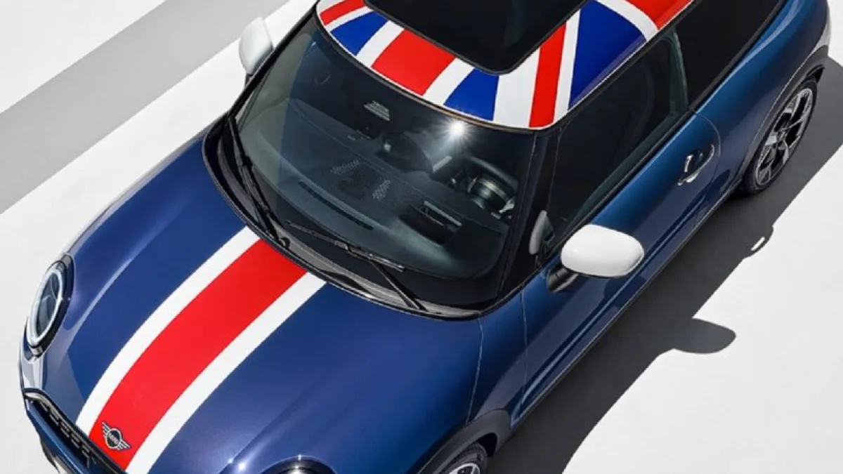 A car with Union Jack-inspired decals on the road