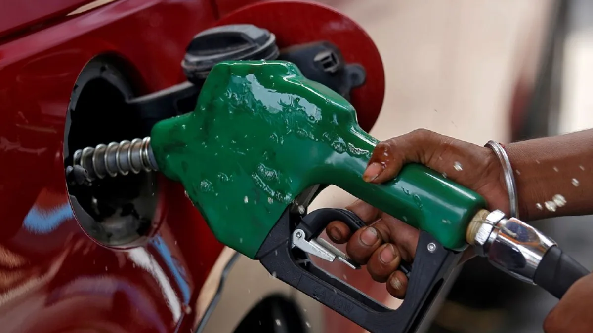 A person filling up their vehicle at a fuel station