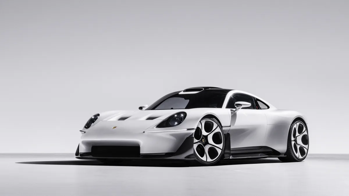 Sports car with low front end and rounded headlamps