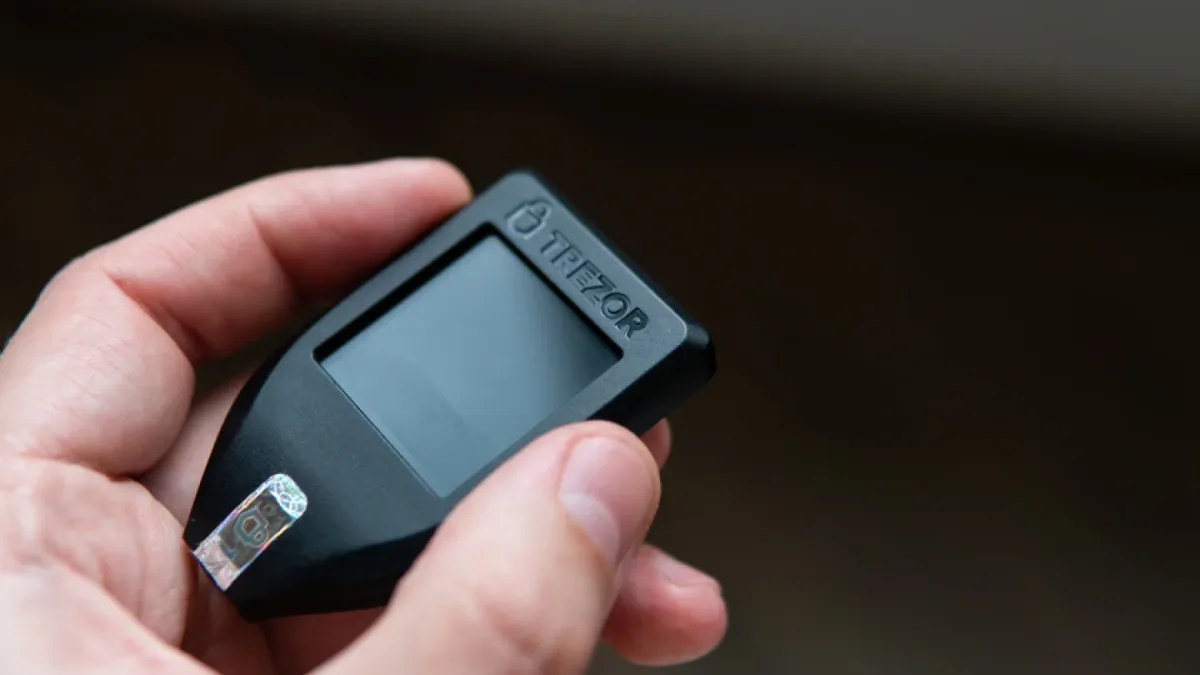 Cryptocurrency user holding a hardware wallet